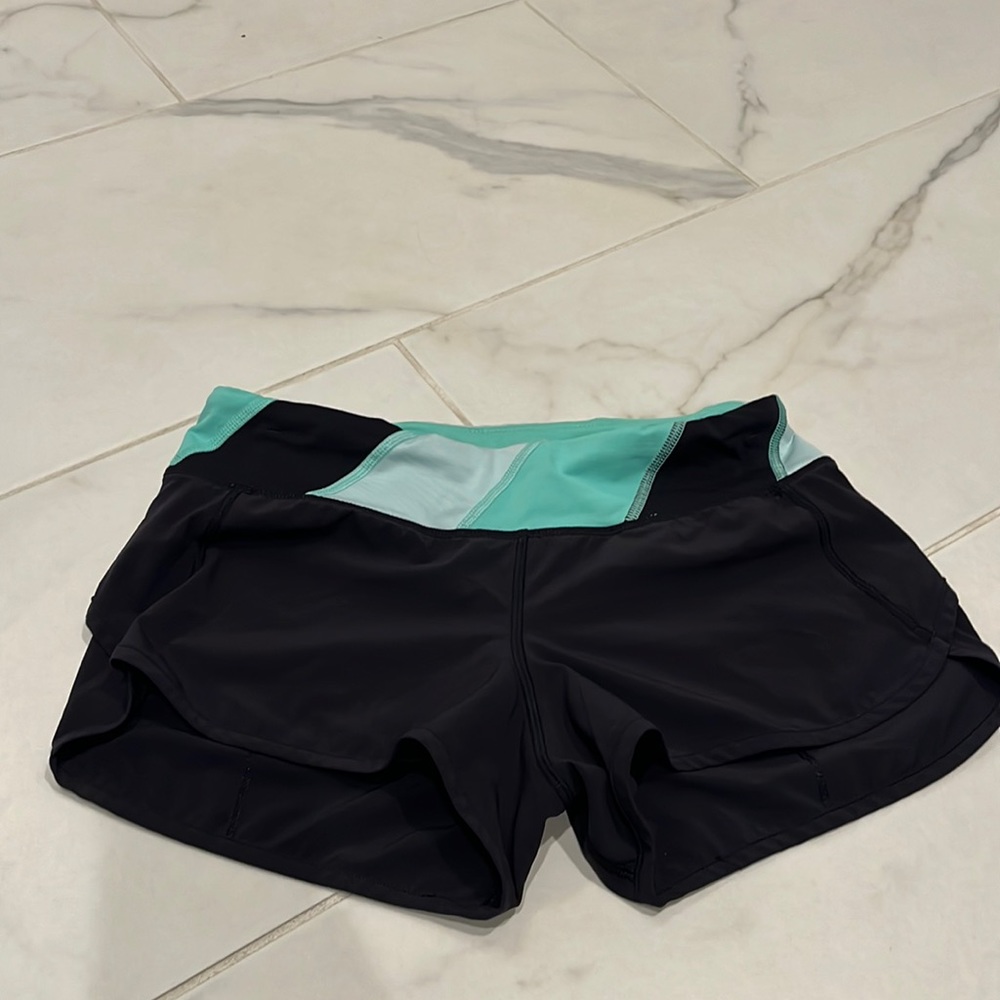 Lululemon size 4 black/mint/blue running shorts.